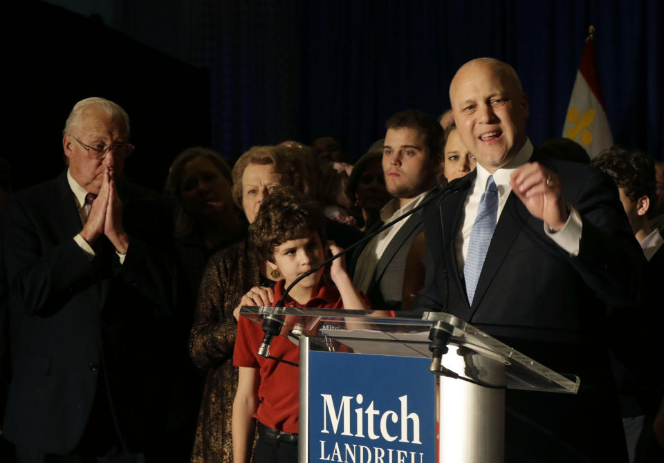 Incumbent New Orleans Mayor Mitch Landrieu addresses supporters after winning reelection in New Orleans, Saturday, Feb. 1, 2014. Far left is his father, former Mayor Moon Landrieu. (AP Photo/Gerald Herbert)