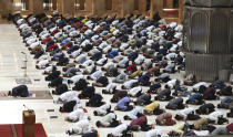 Indonesian Muslims pray spaced apart as they practice social distancing to curb the spread of the new coronavirus during an evening prayer called "tarawih" marking the first eve of the holy fasting month of Ramadan at Istiqlal Mosque in Jakarta, Indonesia. Monday, April 12, 2021. During Ramadan, the holiest month in Islamic calendar, Muslims refrain from eating, drinking, smoking and sex from dawn to dusk. (AP Photo/ Achmad Ibrahim)