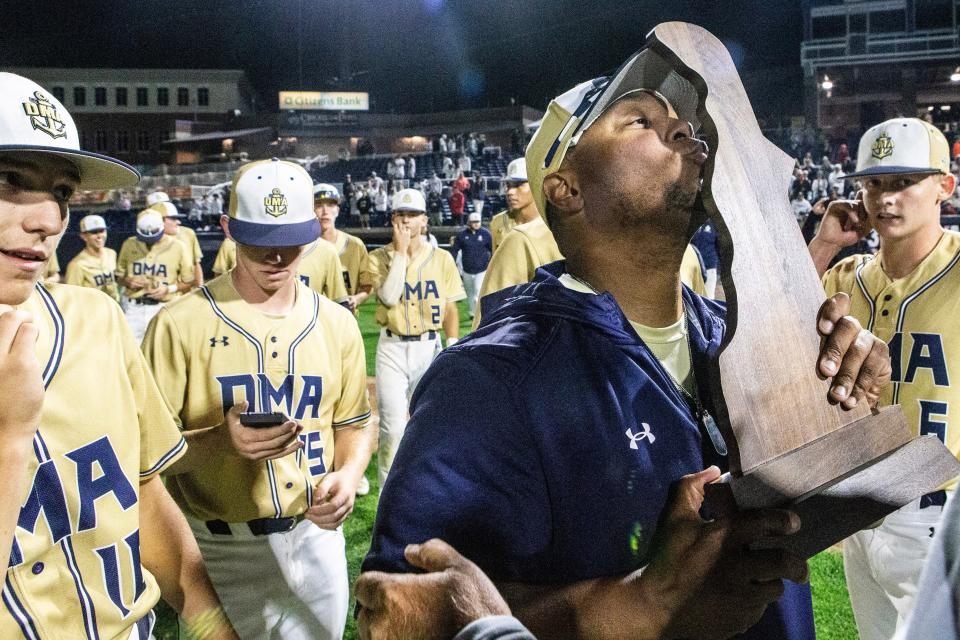 Delaware Military Academy head coach Aaron Lewis kisses the trophy after their 7-1 victory against Conrad during the DIAA Baseball championship game at Frawley Stadium in Wilmington on Saturday, June 3, 2023. DMA won 7-1.