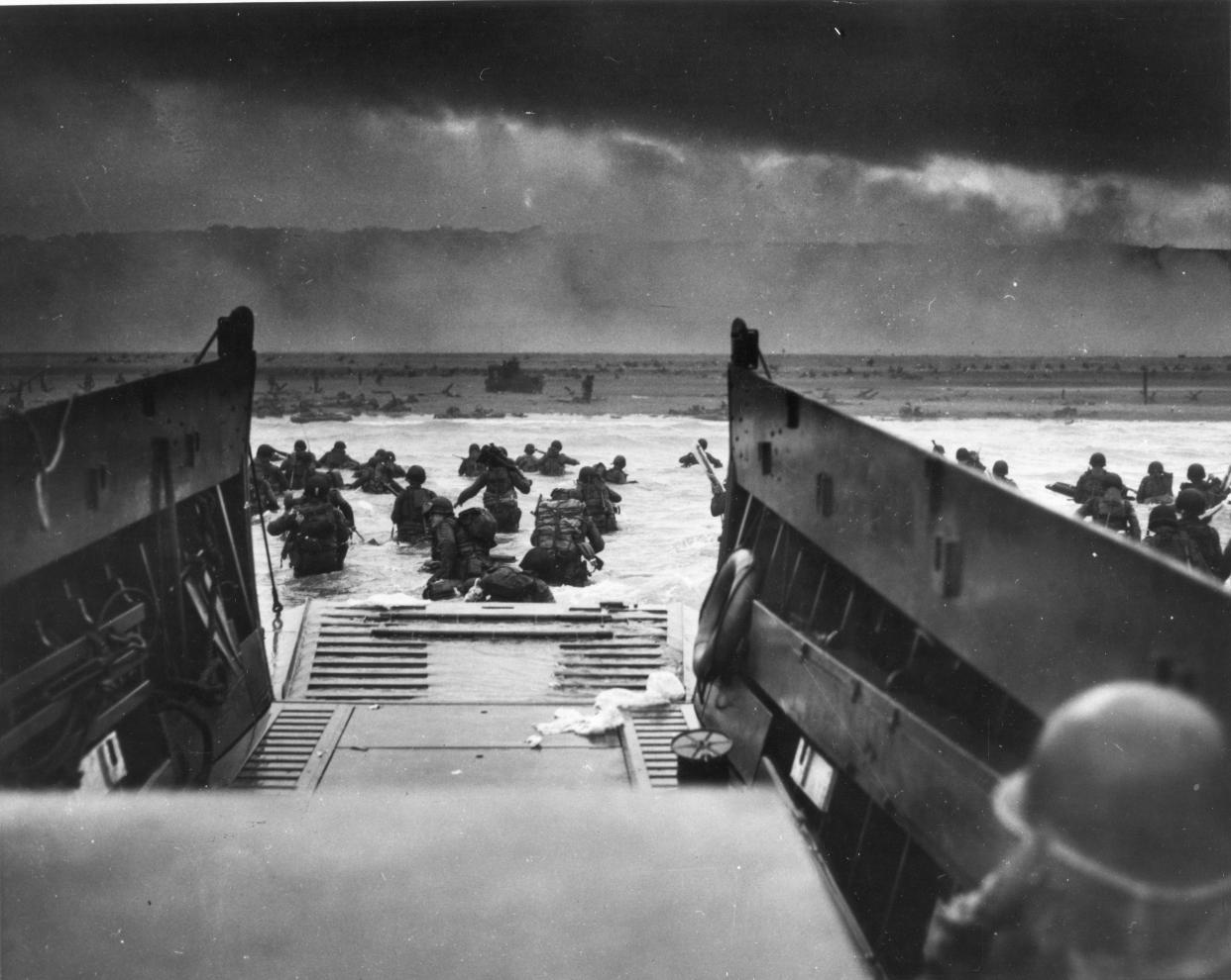 Army troops wade ashore on Omaha Beach during the D-Day landings on June 6, 1944. They were brought to the beach by a Coast Guard manned LCVP.