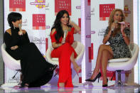 US celebrity Kim Kardashian (C) sits between her mother Kris Jenner (L) and Middle East Broadcasting Centre (MBC) presenter Joelle Mardinian, during an interview in Dubai on October 14, 2011, where they are promoting the UAE's first branch of the Millions Milkshakes store. The reality TV star wed basketball player Kris Humphries, but after about 70 days the pair were separated. (Photo by AFP/Getty Images)