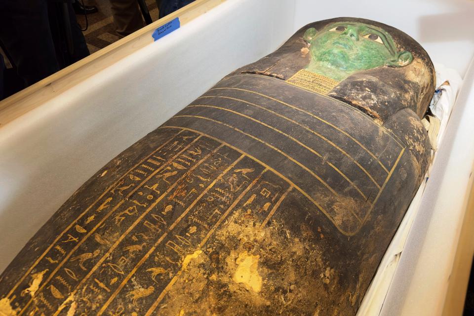 An ancient wooden sarcophagus is displayed during a handover ceremony at the foreign ministry in Cairo, Egypt, Monday, Jan. 2, 2023. An ancient wooden sarcophagus that was featured at the Houston Museum of Natural Sciences was returned to Egypt after U.S. authorities determined it was looted years ago, Egyptian officials said Monday.