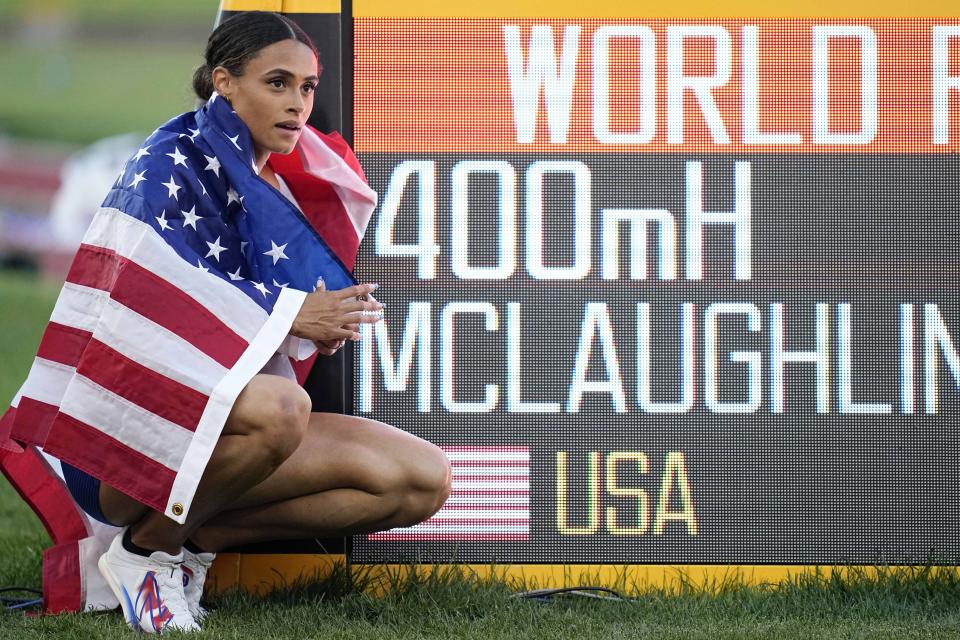 Gold medalist Sydney McLaughlin, of the United States, poses by a sign after winning the final of the women's 400-meter hurdles at the World Athletics Championships on Friday, July 22, 2022, in Eugene, Ore. The running mecca that embedded Nike into American culture was an easy choice to host the first track world championships on U.S. soil. It will take time to determine whether Eugene, Oregon lived up to expectations.They say sagging viewership totals and flat revenue across the broader Olympic world make it critical to bring the cornerstone sport of the games back to its glory days in the U.S. before they return to Los Angeles in 2028. (AP Photo/Ashley Landis)