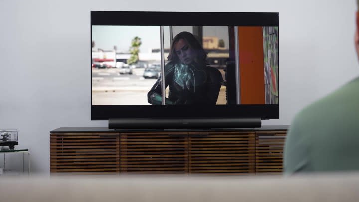 The Sonos Era 300 soundbar under a TV on a media console.