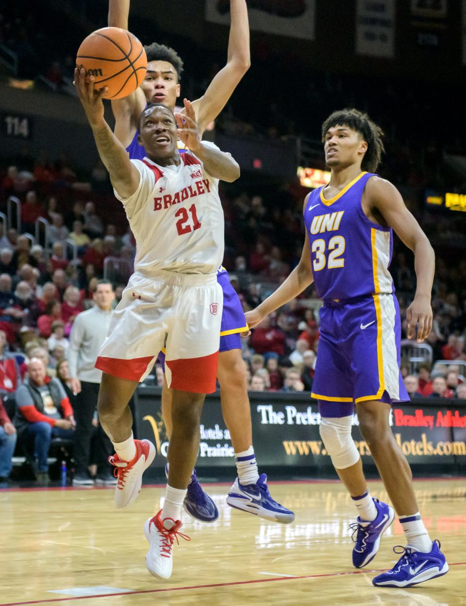 Bradley's Duke Deen (21) gets past Northern Iowa's Tytan Anderson (32) and Trey Campbell for a shot in the first half of their Missouri Valley Conference basketball opener Wednesday, Nov. 30, 2022 at Carver Arena. The Braves defeated the Panthers 68-53.