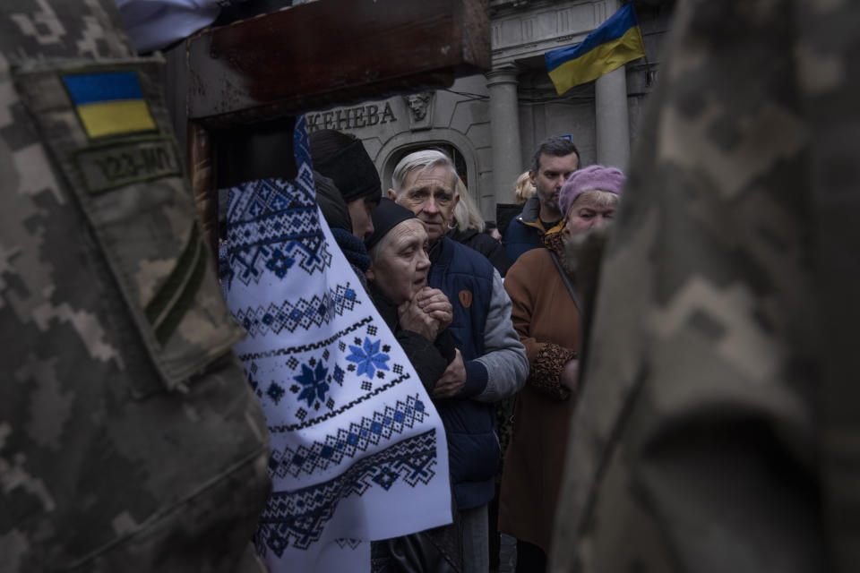 The mother of 40-year-old Senior lieutenant, Oliynyk Dmytro, mourns his death during his funeral ceremony, after being killed in action, outside the Holy Apostles Peter and Paul Church, in Lviv, western Ukraine, Saturday, April 2, 2022. (AP Photo/Nariman El-Mofty)