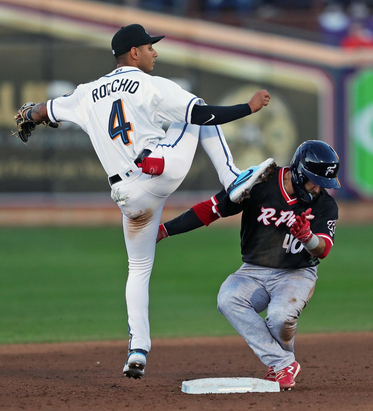 Akron RubberDucks second baseman Brayan Rocchio (4) kicks Reading Fightin Phils catcher Colby Fitch (40) as he attempts a double play during the third inning of a Minor League Baseball game at Canal Park on Tuesday.