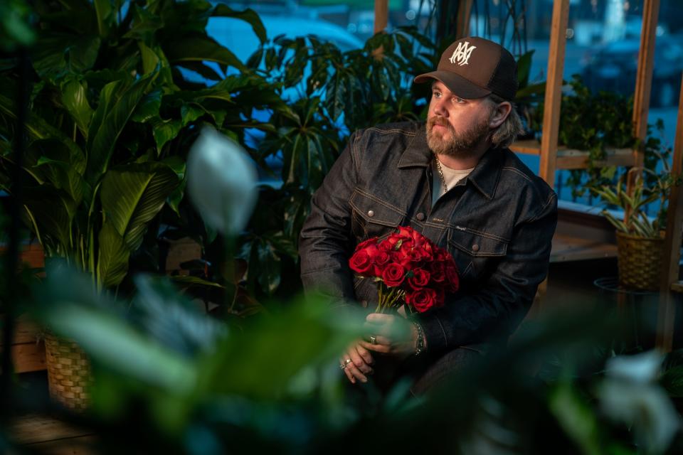 Country music artist Ernest Keith Smith, known as Ernest, poses at Flower Express in Nashville, Tenn., Monday, Jan. 23, 2023. Ernest has an upcoming deluxe album titled “Two Dozen Roses.”