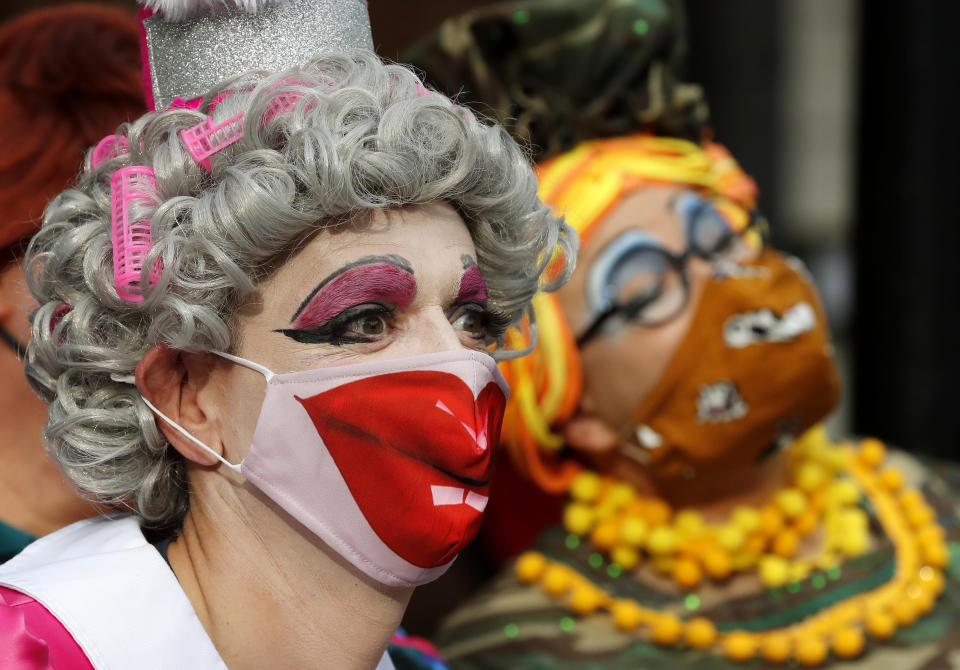 Actors dressed as pantomime dames pose for photographers as they march on Parliament to demand more support for the theatre sector amid the COVID-19 pandemic in London, Wednesday, Sept. 30, 2020. (AP Photo/Frank Augstein)