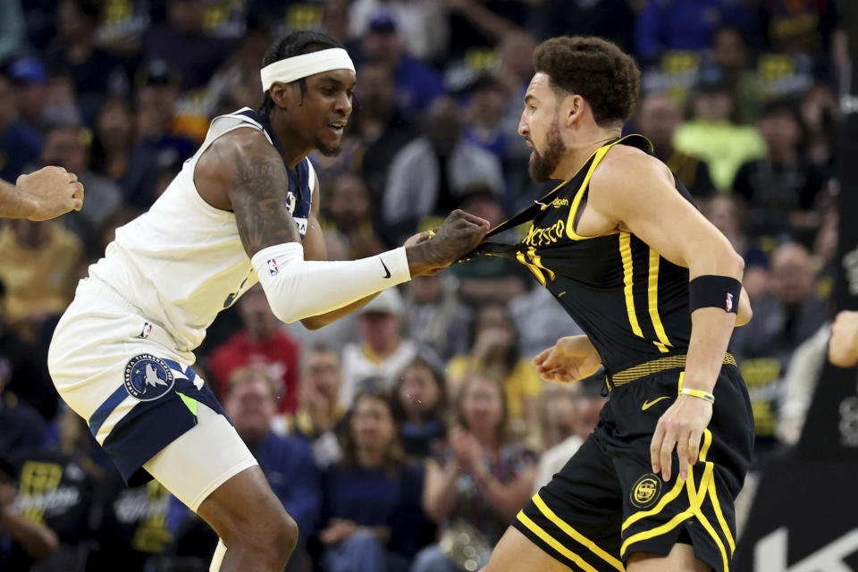 Minnesota Timberwolves forward Jaden McDaniels, left, and Golden State Warriors guard Klay Thompson get into an altercation during the first half of an in-season NBA tournament basketball game in San Francisco, Tuesday, Nov. 14, 2023. They were both ejected from the game. (AP Photo/Jed Jacobsohn)