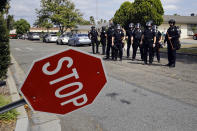 <p>Police officers gather near a broken stop sign while trying to disperse protesters near the Anaheim Convention Center on May 25, 2016, in Anaheim, Calif. (AP Photo/Jae C. Hong) </p>