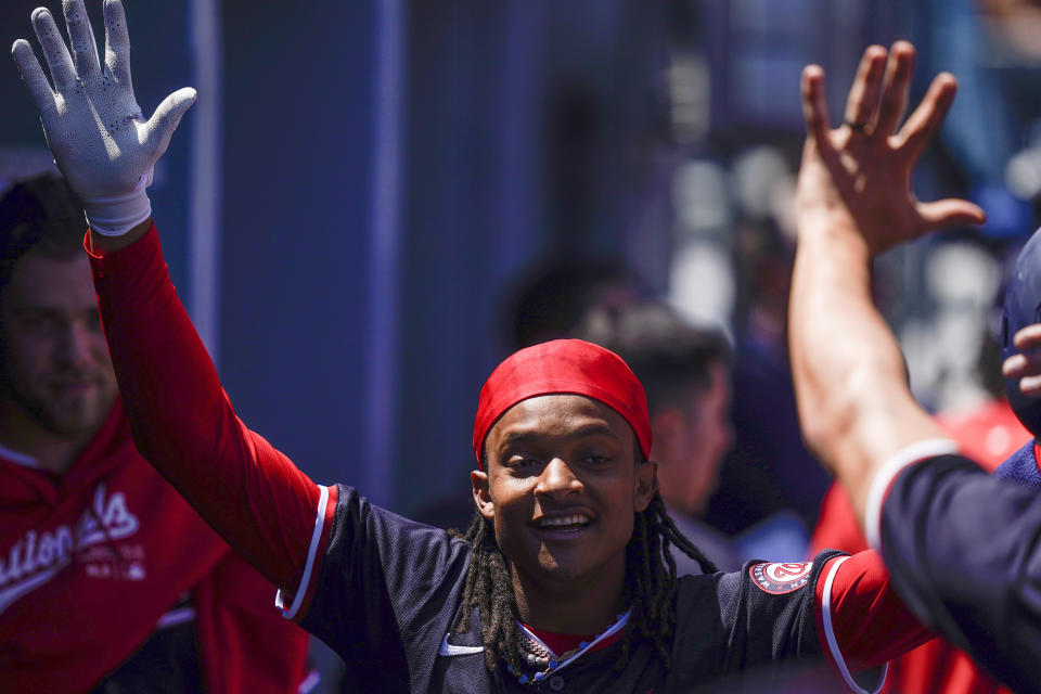 Washington Nationals' CJ Abrams celebrates in the dugout after hitting a home run during the first inning of a baseball game against the Los Angeles Dodgers, Wednesday, April 17, 2024, in Los Angeles. (AP Photo/Ryan Sun)