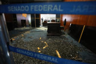 The Senate president's office entrance is destroyed the day after Congress was stormed by supporters of former Brazilian President Jair Bolsonaro in Brasilia, Brazil, Monday, Jan. 9, 2023. The protesters also stormed the presidencial office, Planalto Palace, and the Supreme Court. (AP Photo/Eraldo Peres)