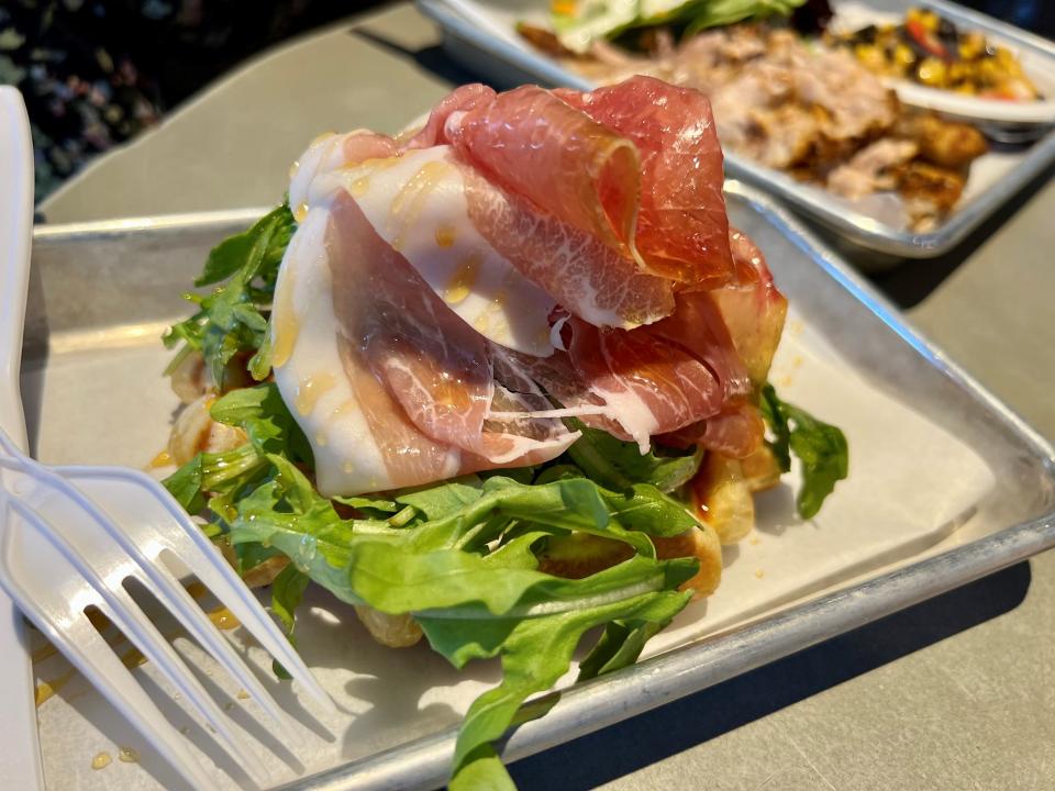 The Whip Di Parma waffle at The Liege Waffle Co. at Assembly Food Hall in downtown Nashville on May 29, 2023. The dish is whipped feta, arugula, prosciutto and hot honey on a waffle.