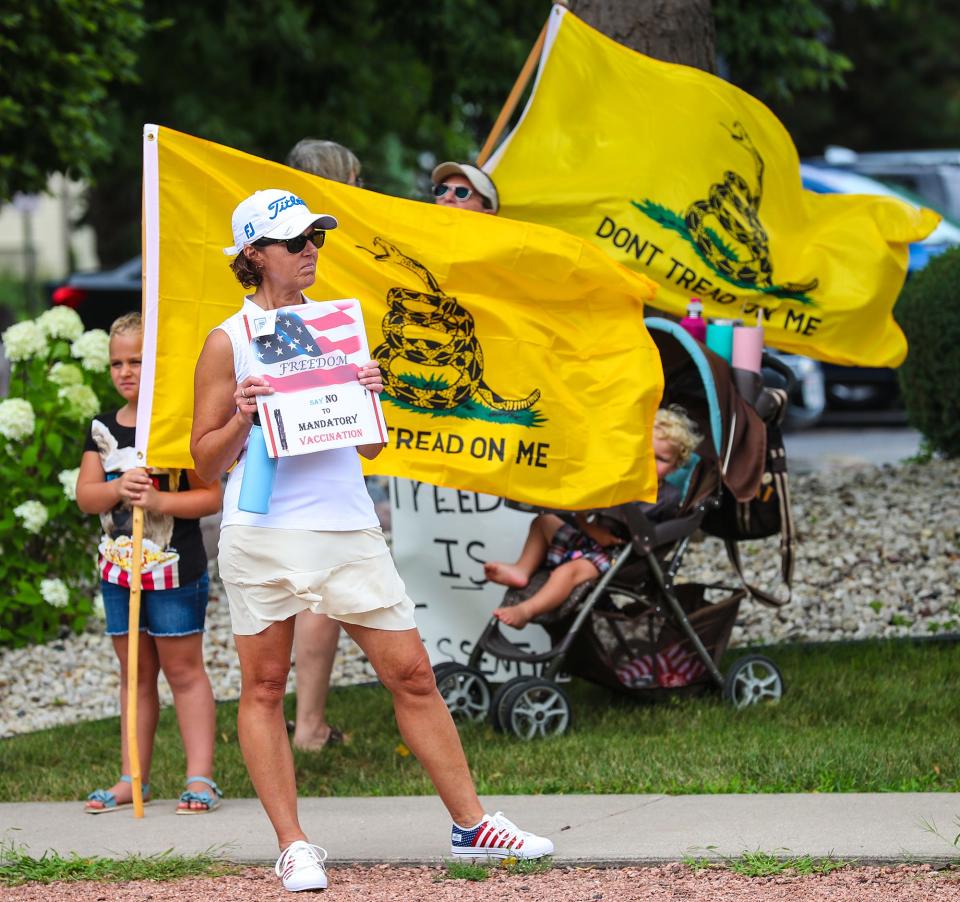 People protest a requirement for all hospital workers to get a COVID-19 vaccination at St. Agnes Hospital in Fond du Lac, Wis., on Aug. 11.