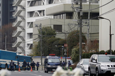 Police officers stand guard near the headquarters of the General Association of Korean Residents in Japan (Chongryon), after police arrested two men suspected of shooting in to the building in Tokyo, Japan, February 23, 2018. REUTERS/Toru Hanai