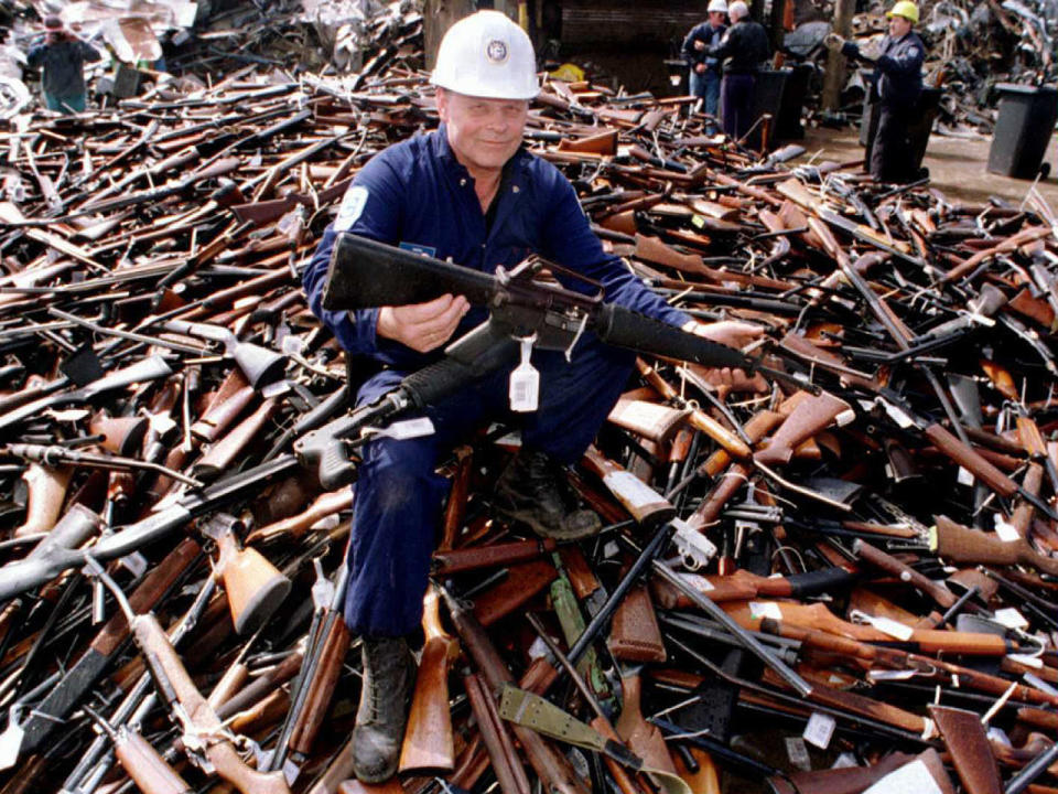 A September 8, 1996 file photo shows Norm Legg, a project supervisor with a local security firm, holding up a rifle similar to the one used in the Port Arthur massacre, and which was handed in for scrap in Melbourne after Australia banned all automatic and semi-automatic rifles in the aftermath of the mass shooting. / Credit: WILLIAM WEST/AFP/Getty