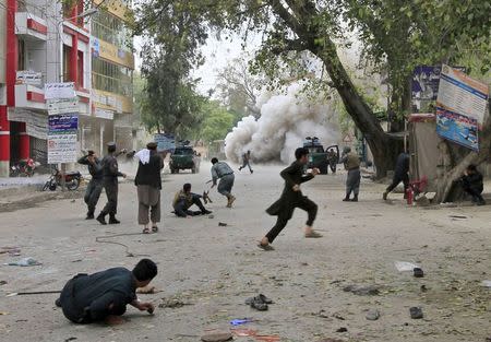 People run for cover after an explosion in Jalalabad April 18, 2015. REUTERS/Parwiz