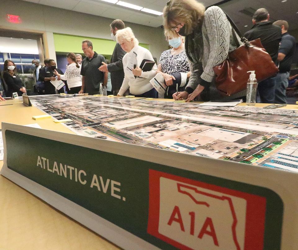 Residents pore over maps of conceptual proposed improvements for beachside roadways during a public meeting at the Ocean Center in Daytona Beach on Wednesday.
