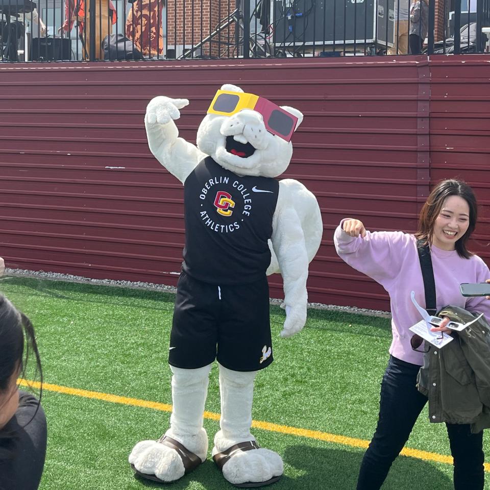 A large squirrel mascot in eclipse glasses.