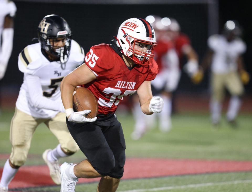 Hilton linebacker John DiBattisto runs back this interception for a touchdown against Rush-Henrietta.