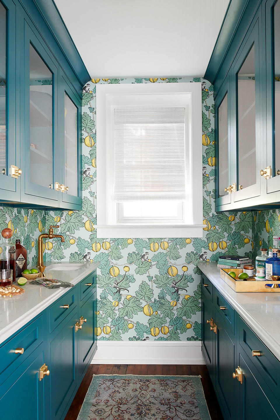 Small blue kitchen with a green and yellow wallpaper