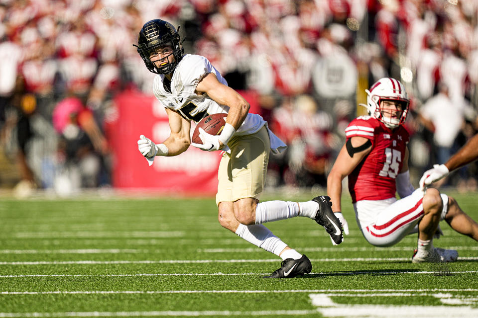 Purdue wide receiver Charlie Jones (15) runs against Wisconsin safety John Torchio during the first half of an NCAA college football game Saturday, Oct. 22, 2022, in Madison, Wis. (AP Photo/Andy Manis)