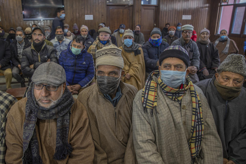 Activists of Jammu and Kashmir National Conference listen to their party president Farooq Abdullah during a meeting a day after the District Development Council elections results in Srinagar, Indian controlled Kashmir, Wednesday, Dec. 23, 2020. An alliance of political parties opposed to New Delhi’s policies in Kashmir has won a majority of seats in local elections, the first since New Delhi revoked the disputed region’s semiautonomous status and took direct control last year. The alliance, which is pro-India but favors self-governance for Kashmir, won 112 out of a total of 280 seats in District Development Council elections. (AP Photo/ Dar Yasin)