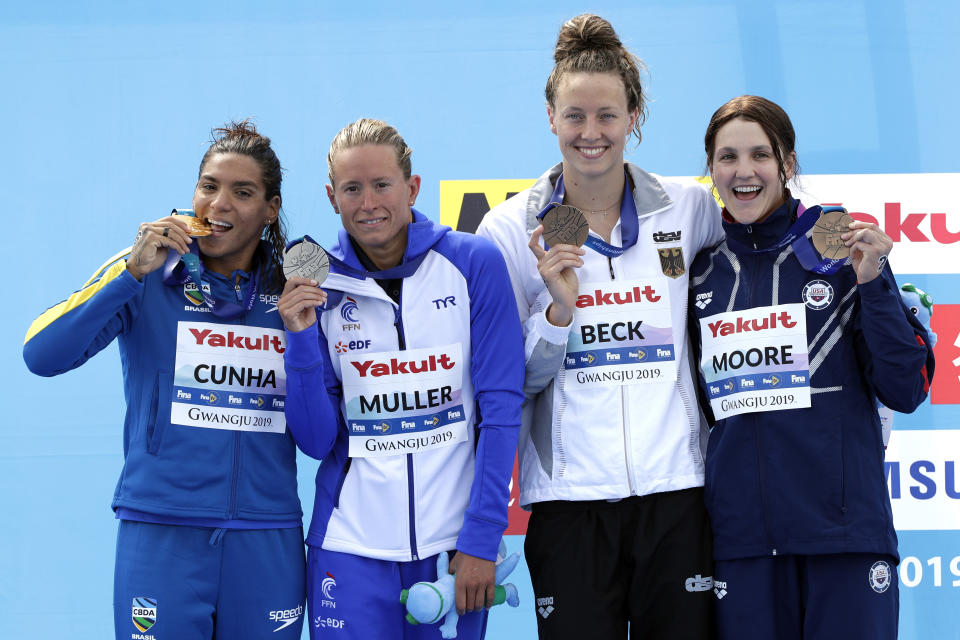 From left, gold medalist Ana Marcela Cunha of Brazil, silver medalist Aurelie Muller of France, and bronze medalists Leonie Beck of Germany and Hannah Moore of the United States stand with their medals after the women's 5km open water swim at the World Swimming Championships in Yeosu, South Korea, Wednesday, July 17, 2019. (AP Photo/Mark Schiefelbein)