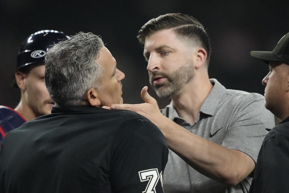 Home plate umpire Manny Gonzalez is checked by the Arizona Diamondbacks trainer after being hit by pitch during the fourth inning of a baseball game against the Atlanta Braves, Thursday, July 11, 2024, in Phoenix. (AP Photo/Matt York)