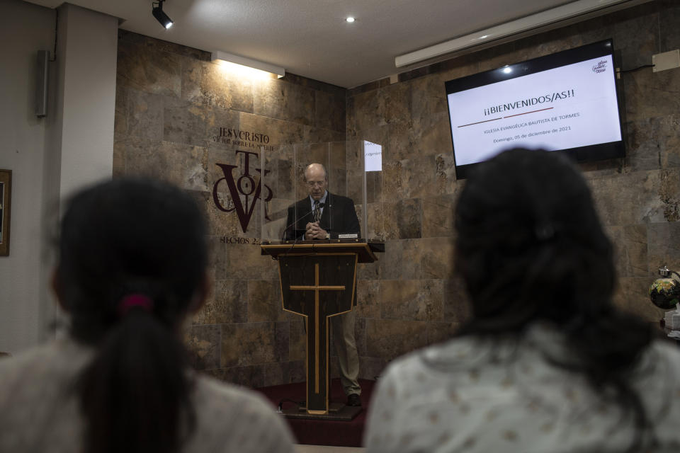 Kent Albright, a Baptist pastor from the United States, conducts Sunday Mass at his evangelical church in Santa Marta de Tormes, outskirts of Salamanca, Spain, on Sunday, Dec. 5, 2021. “The Bible says there are no ethnicities, there are no races. I don’t go down the street asking, nor do I ask for passports at the church door.” Albright said. He marvels that in a course he teaches for deacons, his six students include one each from Peru, Venezuela, Colombia and Ecuador. (AP Photo/Manu Brabo)