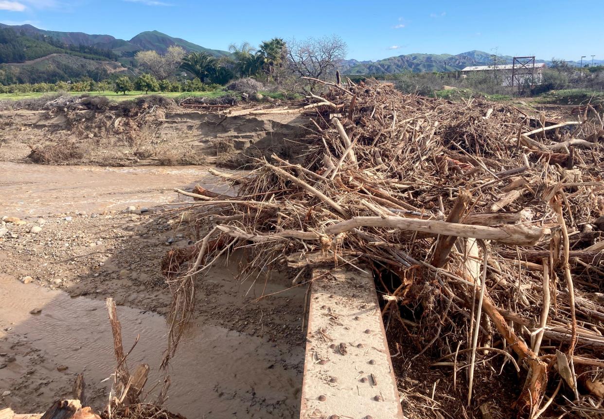 Large piles of wood and debris rest on a railroad bridge near Piru Jan. 17 after recent heavy rains impacted the area.