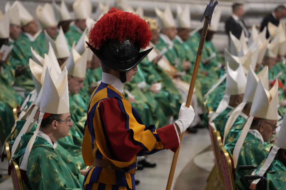 A Vatican Swiss Guard stands at ease during a mass for the new cardinals celebrated by Pope Francis in St. Peter's Basilica at The Vatican Tuesday, Aug. 30, 2022, that concludes a two-day consistory on the Praedicate Evangelium (Preach the Gospel) apostolic constitution reforming the Roman Curia which was promulgated in March. Francis created 20 new cardinals on Saturday. (AP Photo/Andrew Medichini)