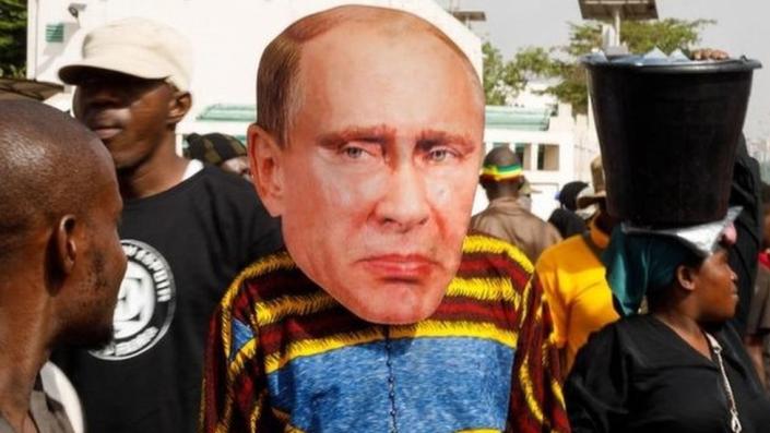 A supporter of Mali's interim president wears a face mask of Russia's President Vladimir Putin during a pro-Junta and pro-Russia rally in Bamako on May 13, 2022