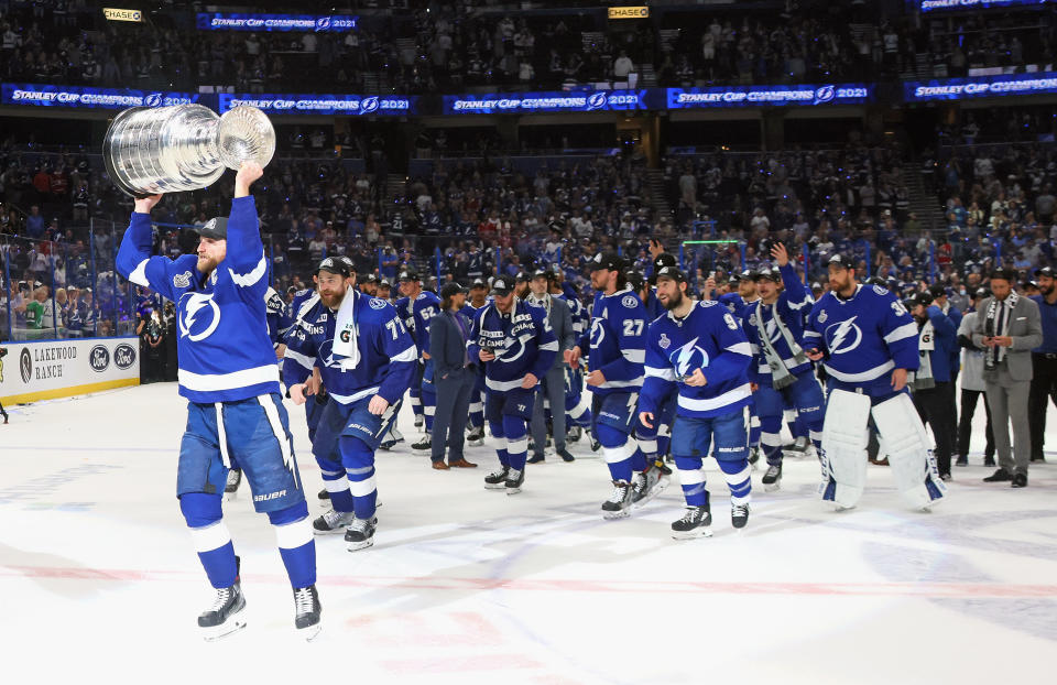 TAMPA, FLORIDA - JULY 07: Steven Stamkos #91 of the Tampa Bay Lightning leads the team around the ice with the Stanley Cup following the victory over the Montreal Canadiens in Game Five of the 2021 NHL Stanley Cup Final at the Amalie Arena on July 07, 2021 in Tampa, Florida. The Lightning defeated the Canadiens 1-0 to take the series four games to one. (Photo by Bruce Bennett/Getty Images)