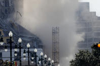 Two large cranes from the Hard Rock Hotel construction collapse come crashing down after being detonated for implosion in New Orleans, Sunday, Oct. 20, 2019. New Orleans officials set off several explosions Sunday intended to topple two cranes that had been looming over the ruins of a partially collapsed hotel. (AP Photo/Gerald Herbert)