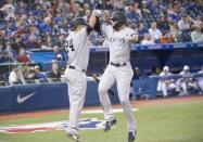 Mar 29, 2018; Toronto, Ontario, CAN; New York Yankees right fielder Giancarlo Stanton (27) celebrates a home run with catcher Gary Sanchez (24) in the ninth inning during the Toronto Blue Jays home opener at Rogers Centre. The New York Yankees won 6-1. Mandatory Credit: Nick Turchiaro-USA TODAY Sports