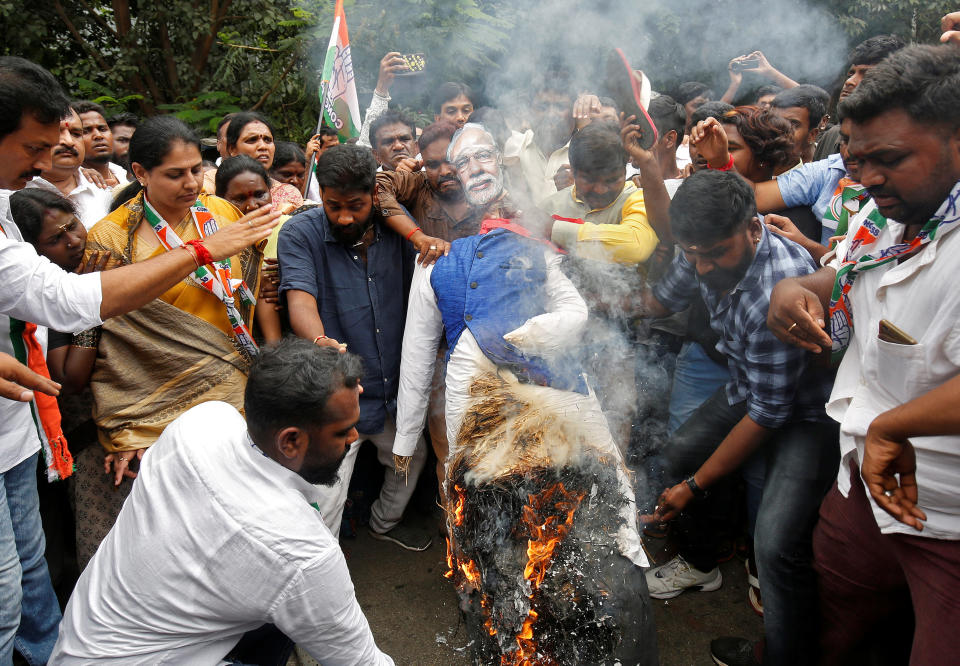 Congress party supporters burn an effigy of India’s PM Modi