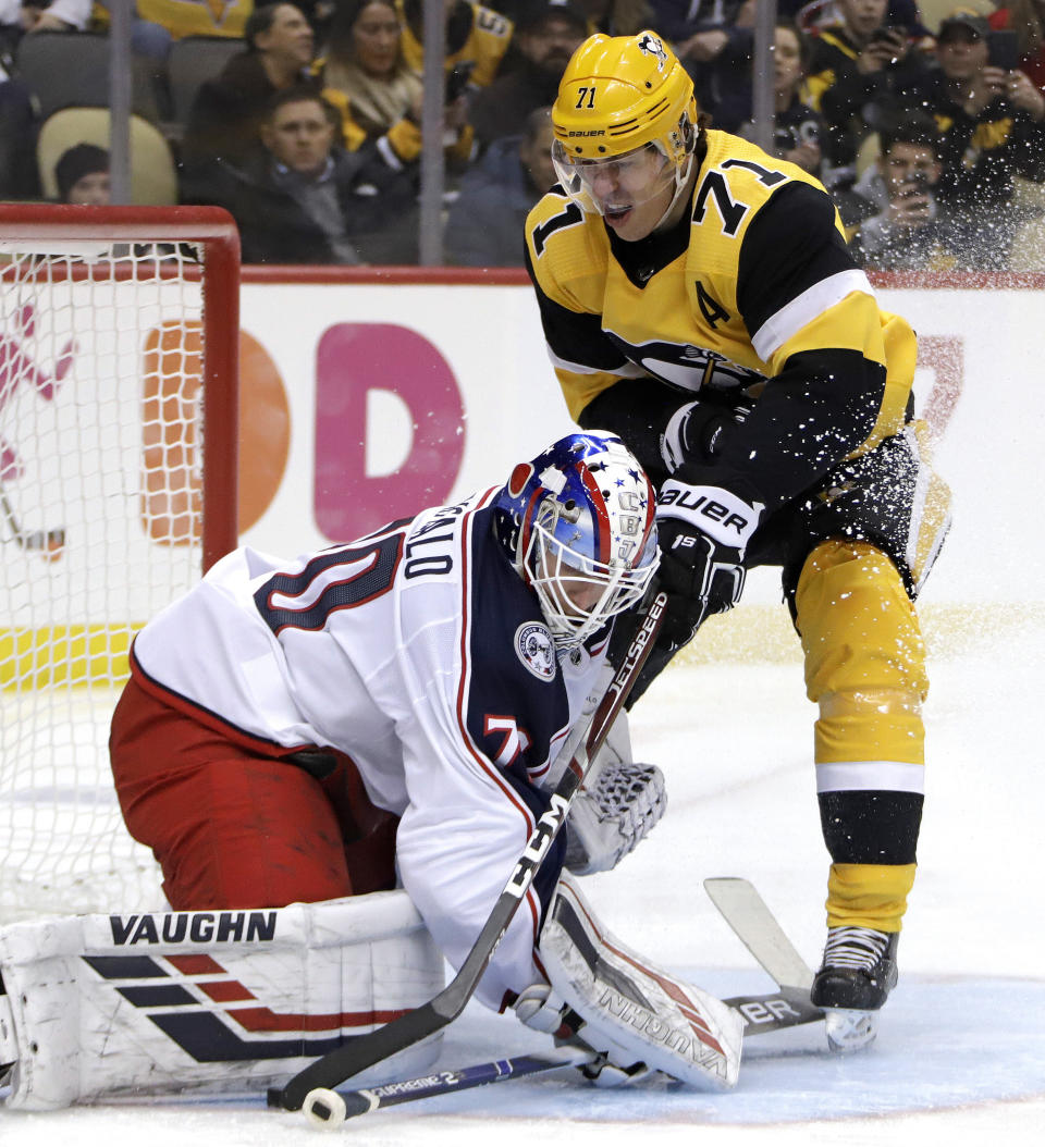 Pittsburgh Penguins' Evgeni Malkin (71) can't get a shot past Columbus Blue Jackets goaltender Joonas Korpisalo during the second period of an NHL hockey game in Pittsburgh, Thursday, March 7, 2019. (AP Photo/Gene J. Puskar)