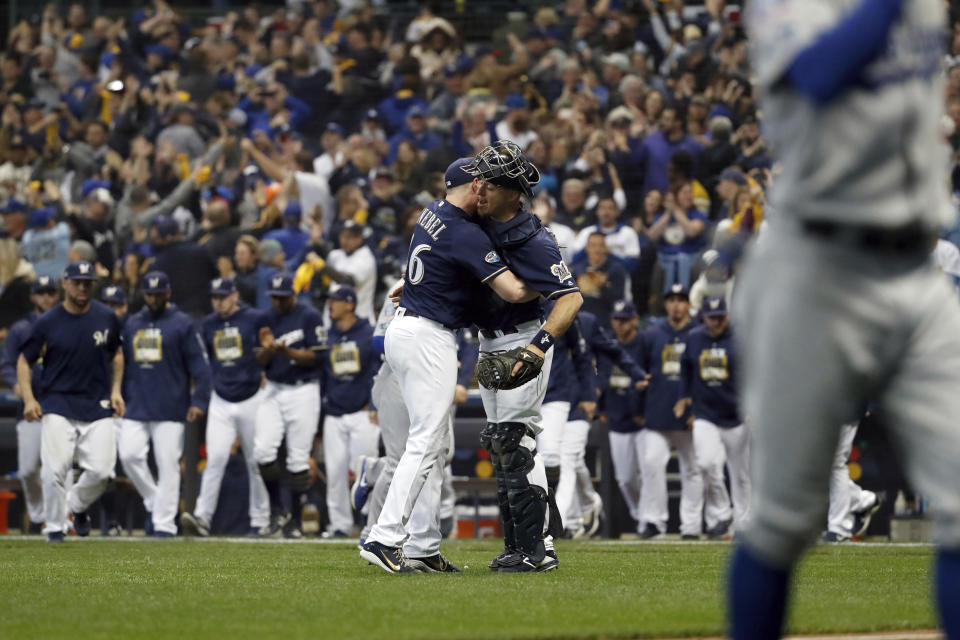 Milwaukee Brewers relief pitcher Corey Knebel (46) and catcher Erik Kratz celebrate after Game 1 of the National League Championship Series baseball game against the Los Angeles Dodgers Friday, Oct. 12, 2018, in Milwaukee. The Brewers won 6-5. (AP Photo/Jeff Roberson)