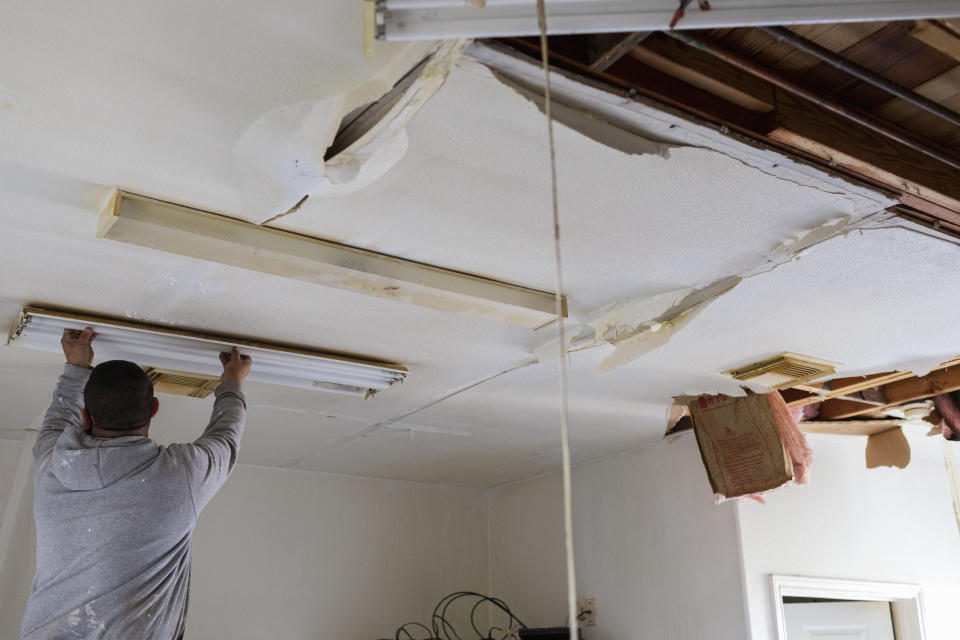 A volunteer helps clean debris from water damage at a local bakery in Baytown, Texas, U.S., on Saturday, Feb. 20, 2021. (Photographer: Zach Chambers/Bloomberg)