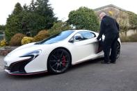 Abbosh stands next to McLaren at his home in Farnham