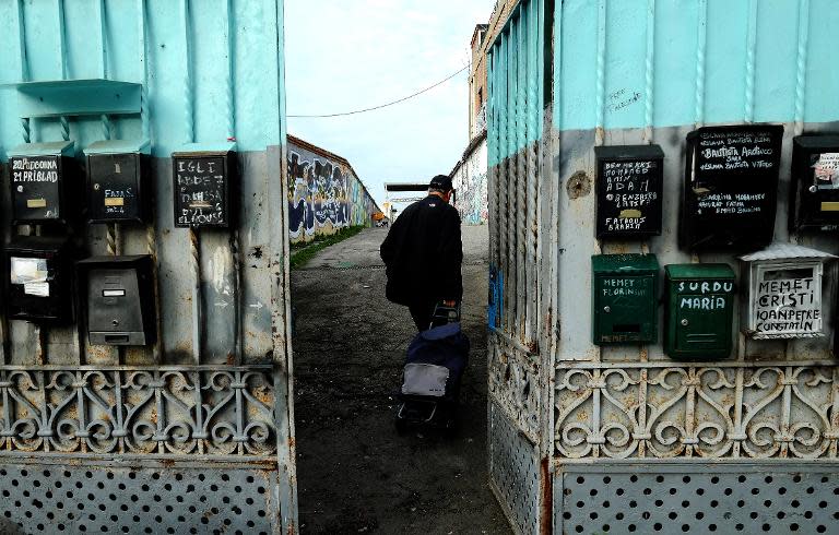 A visitor enters the Metropoliz Museum of the Other and the Elsewhere (MAAM), which is also home to 200 squatters, including Roma and people from all corners of the globe, in Rome, on November 25, 2014