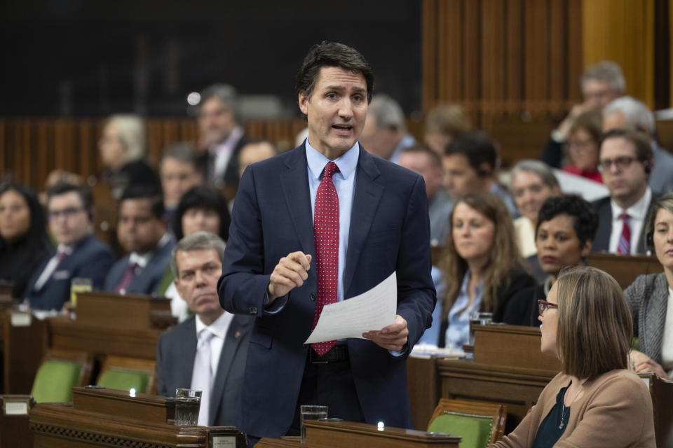 Canada Prime Minister Justin Trudeau reads a statement about the situation at the border during the Question Period, Wednesday, Nov. 22, 2023, in Ottawa, Ontario. Two people were found dead in a vehicle that exploded at a checkpoint on the American side of a U.S.-Canada bridge in Niagara Falls, Wednesday, a law enforcement official told The Associated Press. (Adrian Wyld/The Canadian Press via AP)