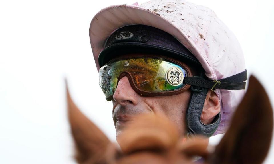 A muddy Gérald Mossé riding on a wet day at Ascot.