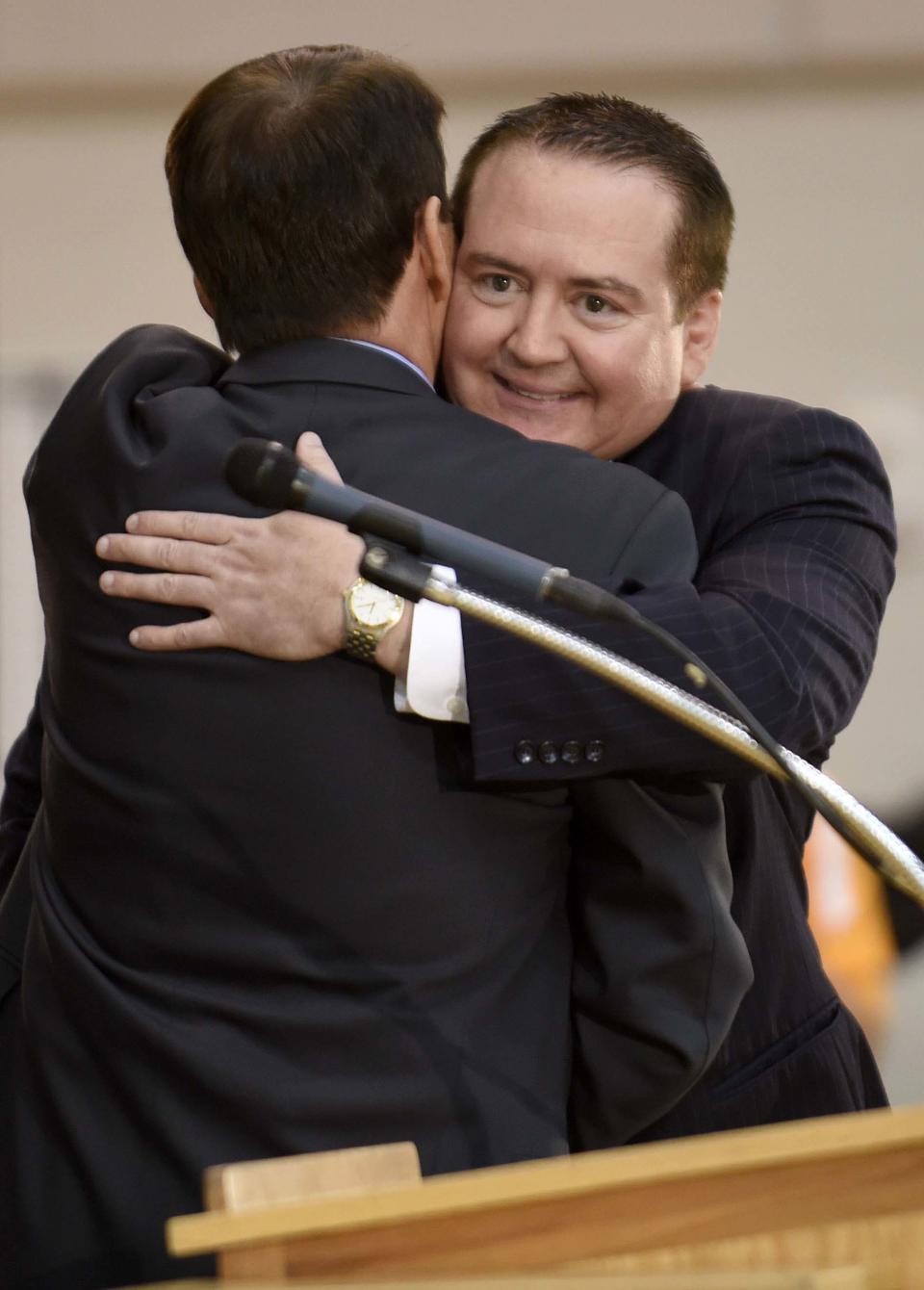 Tennessee men's basketball coach Donnie Tyndall, right, is hugged by athletic director Dave Hart during a news conference Tuesday, April 22, 2014, in Knoxville, Tenn. The former Southern Mississippi coach succeeds Cuonzo Martin, who resigned last week to take the head job at California. (AP Photo/Knoxville News Sentinel, Amy Smotherman Burgess)