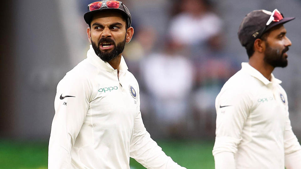 Virat Kohli has words with Tim Paine at stumps. (Photo by Ryan Pierse/Getty Images)