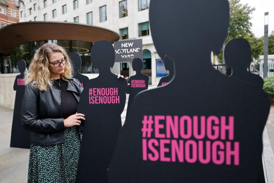 A campaigner outside New Scotland Yard in London on October 7, 2021, part of an action by Refuge, the domestic abuse charity (AFP via Getty Images)