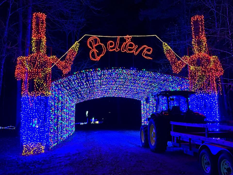 A tractor sits ready to give guests a hay ride through the iconic "Believe" archway at Lights of the South in Grovetown on Monday, Nov. 27, 2023.