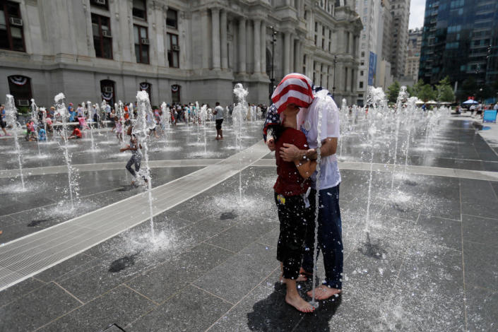 <p>Two supporters of Sen. Bernie Sanders cool off in a fountain at City Hall during a rally in Philadelphia, Tuesday, July 26, 2016, during the second day of the Democratic National Convention. (Photo: Matt Slocum/AP)</p>